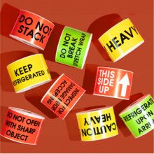 Rolls of package labels for shipping, moves, warnings, hazards, merchandise, and handling needs