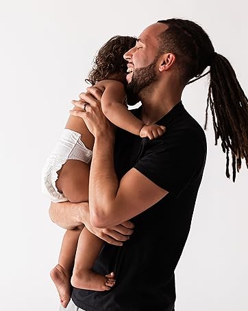 Dad holding baby wearing DYPER diaper