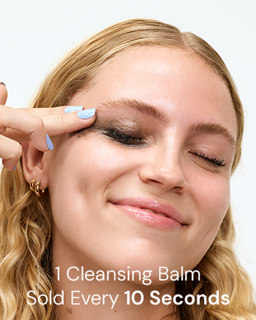 Elemis 1 Cleansing Balm Sold Every 10 Seconds. Model applying cleansing balm to remove makeup.